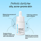 A white dropper bottle of Nooran Prebiotic Acne Clarity Serum centered on a light blue gradient background with callout text describing skincare benefits.